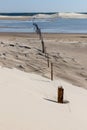 Wood and iron Fence over lake with dunes Royalty Free Stock Photo