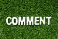Wood letter in word comment on artificial green grass background
