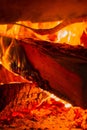 Wood log burning in the chimenea. Fire wood, coal and amber ash closeup. Red tongues of flame and glowing amber. Royalty Free Stock Photo