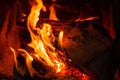 Wood log burning in the chimenea. Fire wood, coal and amber ash closeup.