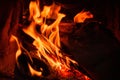 Wood log burning in the chimenea. Fire wood, coal and amber ash closeup