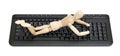 Wood mannequin on a keyboard