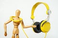 Wood marlakang dance next to yellow headphone isolated with white background