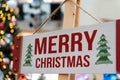 Wood Merry Christmas sign hanging on the timber column Royalty Free Stock Photo