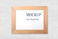 Wood narrow photo frame with mock up space on white wall. Royalty Free Stock Photo