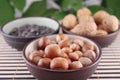 Wood nuts in cup on bamboo napkin Royalty Free Stock Photo