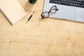 Wood office desk table with blank notebook, laptop computer, pen, glasses, succulent plant. Minimal flat lay style composition, Royalty Free Stock Photo