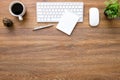 Wood office desk table with computer keyboard with mouse, blank notebook, cup of coffee and supplies. Top view with copy space, Royalty Free Stock Photo