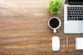 Wood office desk table with laptop computer, coffee cup and supplies with sun light in the morning. Top view with copy space, flat Royalty Free Stock Photo