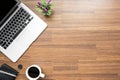 Wood office desk table with laptop computer, cup of coffee and supplies. Top view with copy space, flat lay Royalty Free Stock Photo