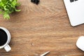 Wood office desk table with laptop computer, cup of coffee and supplies. Top view with copy space, flat lay Royalty Free Stock Photo