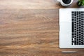 Wood office desk table with laptop computer, cup of coffee and supplies. Top view with copy space, flat lay Royalty Free Stock Photo