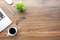 Wood office desk table with laptop computer, cup of coffee and supplies. Top view with copy space, flat lay Royalty Free Stock Photo