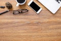 Wood office desk table with laptop computer, smartphone, cup of coffee and office supplies. Top view with copy space, flat lay Royalty Free Stock Photo