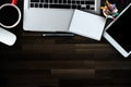 Wood office desk table with a lot of things tablet, laptop ,smartphone ,notepad and coffee cup notepad . Top view with copy space Royalty Free Stock Photo