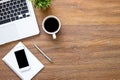 Wood office desk table with smartphone, laptop computer and supplies. Top view with copy space, flat lay Royalty Free Stock Photo