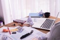 Wood office table with laptop and paperwork, latte coffee cup, crumpled paper Royalty Free Stock Photo