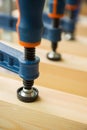 Wood pasting by clamps in a joiner's workshop Royalty Free Stock Photo