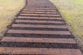 Wood path walkway & green grass lawn in perspective view Royalty Free Stock Photo