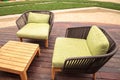 Wood patio lounge chairs with green cushions Royalty Free Stock Photo