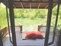 Wood patio on a relaxing green pond with bamboo mat and pillows