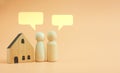 Wood peg doll with pop up of empty speech bubbles and a wood house, planning concept Royalty Free Stock Photo