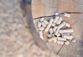 Wood pellets on a log of wood with a blurred background Royalty Free Stock Photo