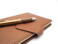 Wood pen with leatherette book on white background