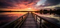 Quay pier deck over a vibrant sunset lake reflection.