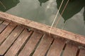 Wood pier over oily waters with reflected boats Royalty Free Stock Photo