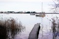 Wood pier pontoon access fishing boat in lake winter morning Royalty Free Stock Photo