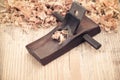 Wood planer on wooden background Royalty Free Stock Photo