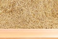 Wood plank on straw, empty wood table floors on straw hay dry background, wood table board empty front straw wall backdrop