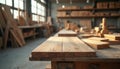 Wood planks lie on the workbench in carpentry shop. Many tools and materials are in background. Carpentry workshop is illuminated Royalty Free Stock Photo