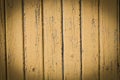 Wood planks, old yellow paint peeling off background texture Royalty Free Stock Photo