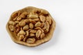 Wood plate of salted peanuts Royalty Free Stock Photo