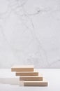 Wood podium of planks with sunlight and shadow for presentation and product display on white wood table and marble wall, vertical. Royalty Free Stock Photo