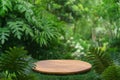 Wood podium table top floor in outdoors tropical garden forest blurred green leaf plant nature background.Natural product