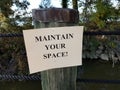 wood post with maintain your space sign order