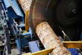 Wood processing at a sawmill. Preparation of a log for the production of plywood and veneer, sawing and cleaning of blanks in a Royalty Free Stock Photo