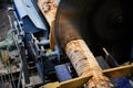 Wood processing at a sawmill. Preparation of a log for the production of plywood and veneer, sawing and cleaning of blanks in a Royalty Free Stock Photo