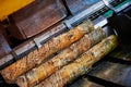 Wood processing at a sawmill. Preparation of a log for the production of plywood and veneer, sawing and cleaning of blanks in a Royalty Free Stock Photo