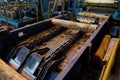 Wood processing at a sawmill. Preparation of a log for the production of plywood and veneer, sawing and cleaning of blanks in a Royalty Free Stock Photo