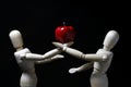 Wood robot and mini apple in action . Royalty Free Stock Photo