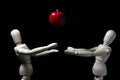 Wood robot and mini apple in action . Royalty Free Stock Photo