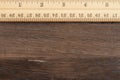 Wood ruler with brown weathered grained wood background