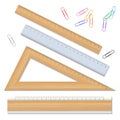 Wood school rulers and color paperclips isolated on white background.