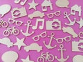 Wood shapes stars bikes anchors music notes cars on a pink background Royalty Free Stock Photo