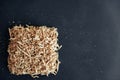 Wood shavings on black background. Background of fresh wood shavings. Copy, empty space for text Royalty Free Stock Photo