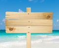 Wood sign in the beach. Royalty Free Stock Photo